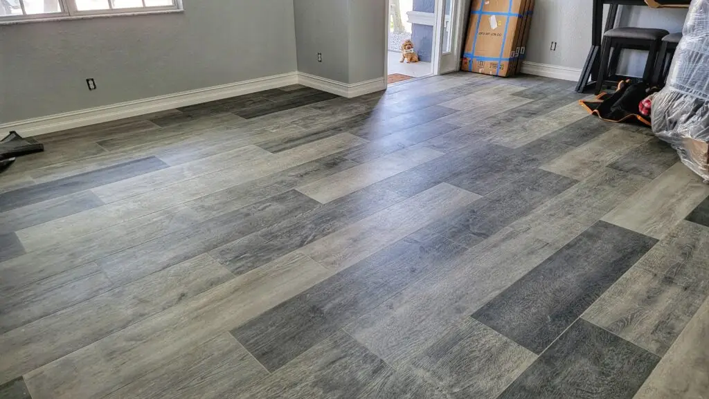 12x48-inch wood-look porcelain plank tile in mixed gray tones, installed in a staggered layout in a Cape Coral home